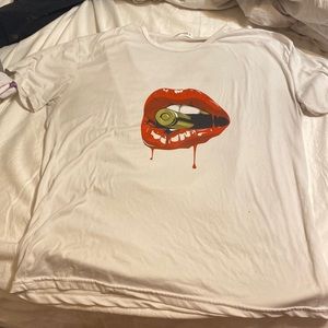 White shirt with red lips and a gold bullet inside the red lips